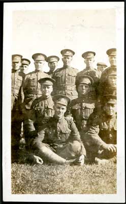 Photograph of 12 soldiers with 2 seated on the grass