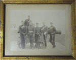 Photo of 6 soldiers with 1 seated on a cannon