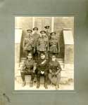 Photograph of 8 soldiers on the steps of the Cayuga Town Hall