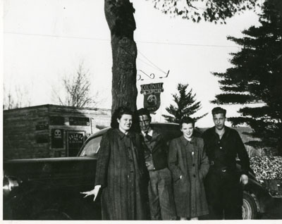 Doris Donnelly, Elmer Donnelly, Joan Charbonneauand Joe Bouillon standing in front of Pat Collin's store
