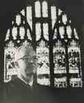 Reverend Robert MacMillan in front of Last supper memorial Window.