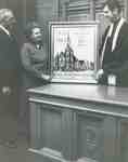Rev. Cam Taylor, (right) with Walter Adamson, clerk of Session, and wife Dorothy Adamson beside her gift to the congregation of a petitepoint design of Knox Church on the 150th anniversary.