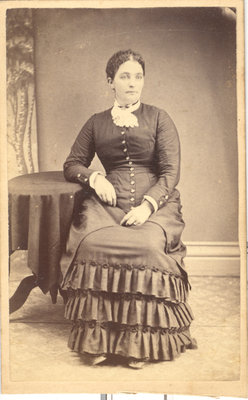 Young Woman Seated at Round Table