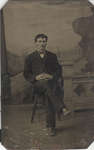 Young Man Seated in Front of Background