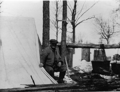 George Bass making maple syrup on his farm c.1925