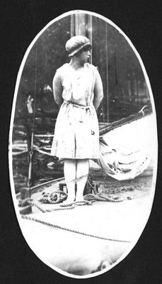 Woman in bathing suit by sailboat at Fettercairn Island