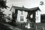 Family in Front of a Rural Home Covered in Ivy, c. 1902-1906