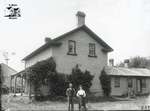 Man and Woman With Brick Farmhouse, c. 1902-1906