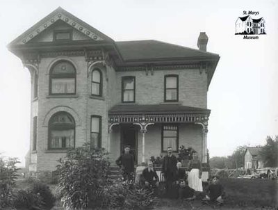 Group Portrait with Large Brick House, c. 1902-1906