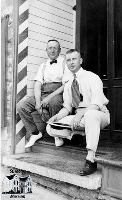 Two Men on Steps of Barber Shop