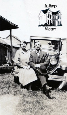 Couple Sitting on the Hood of an Old Car