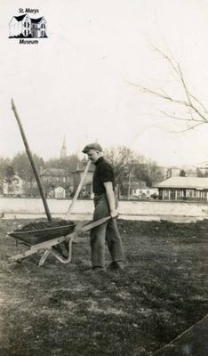 Harvey Ball Jr. Pushing a Wheelbarrow