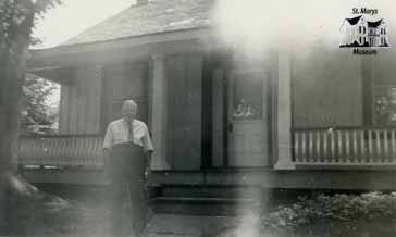 Man Stands Outside of House on Wellington St. N.