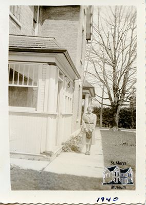 Isabelle Chesterfield Standing Beside Her Family Home