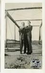 Two Men Standing on a Bridge