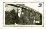 Bruce Chesterfield Standing Beside House with Ivy