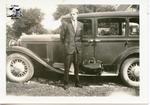 Norman Chesterfield Standing in Front of a Car