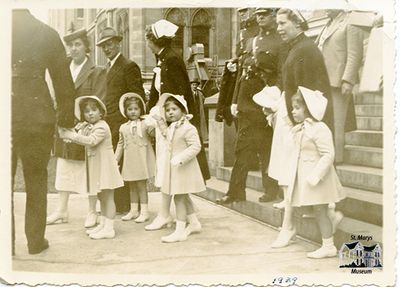 Nurses and Soldiers Escorting Small Girls Out of Building