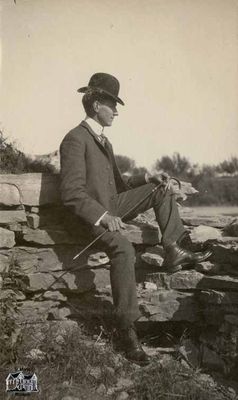 Man Sitting on Rock Ledge