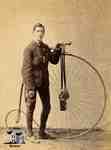 Man and penny farthing bicycle