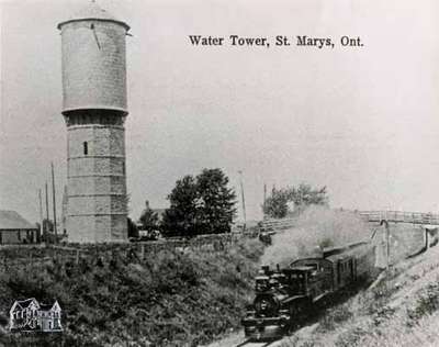 Water Tower with GTR steam engine passing under the Queen Street overpass; early 1900s