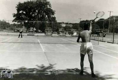 Two men playing at the tennis courts, ca. 1950