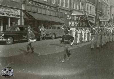 Two views of Queen Street during a parade