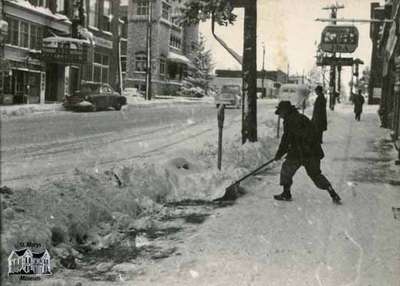 Snow shoveling on Queen Street East, ca. 1960