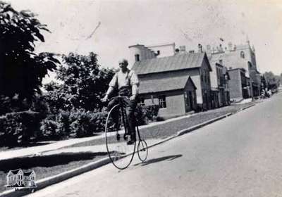 John Brown riding a penny farthing bicycle