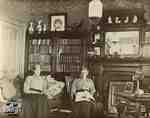 Mrs. Clench and Miss Cruttenden in the living room of the Clench home