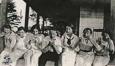 Groups posing on house porch (2 photos)