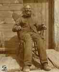 James (Jimmy) Tate seated in his rocking chair