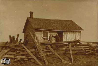 James (Jimmy) Tate standing in front of his cabin