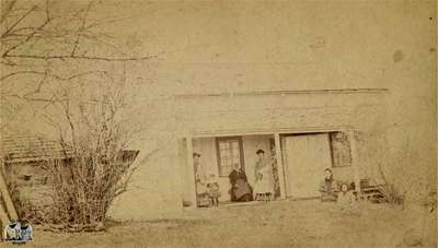 Six people in front of a house