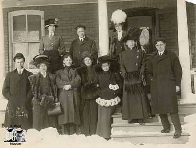 Group standing outside home in winter