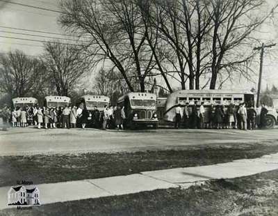 High school students boarding buses