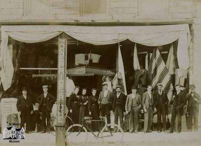 White and May storefront with staff