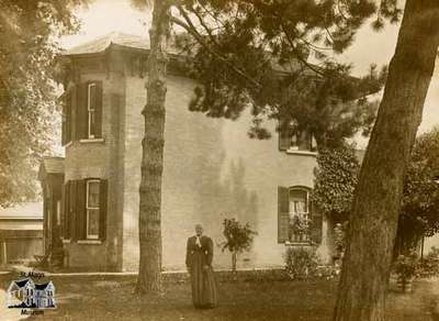 Margaret Grant standing in front of her house, King Street South