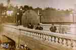 Four men standing on Wellington Street bridge