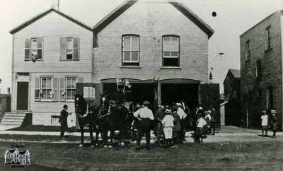 Fire Station with horses and people out front