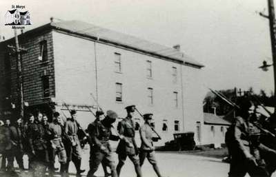 Soldiers marching on Queen Street (corner of Queen and Wellington Streets)