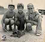 Three boys with a snapping turtle