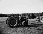 Men Conversing Next to a Tractor