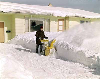 Unidentified Man Using a Snow Blower