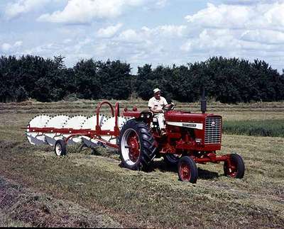 Unidentified Man Raking a Field