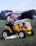 Unidentified Man Mowing a Lawn