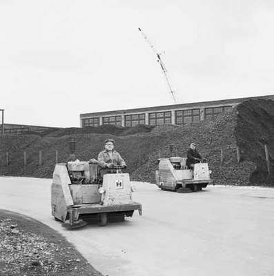 Two Unidentified Men Driving Street Clearners