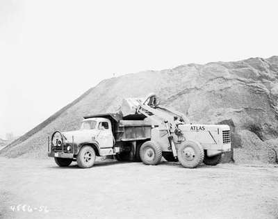 Tractor Dumping a Load into a Truck, Gagetown, NB