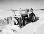 Snow removal with an IHC I660 model tractor, and a tractor mounted snow thrower.