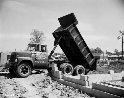 IHC Dump truck, model ACF 180, owned by Bouchard Haulage, Hamilton,unloading at a housing construction site.